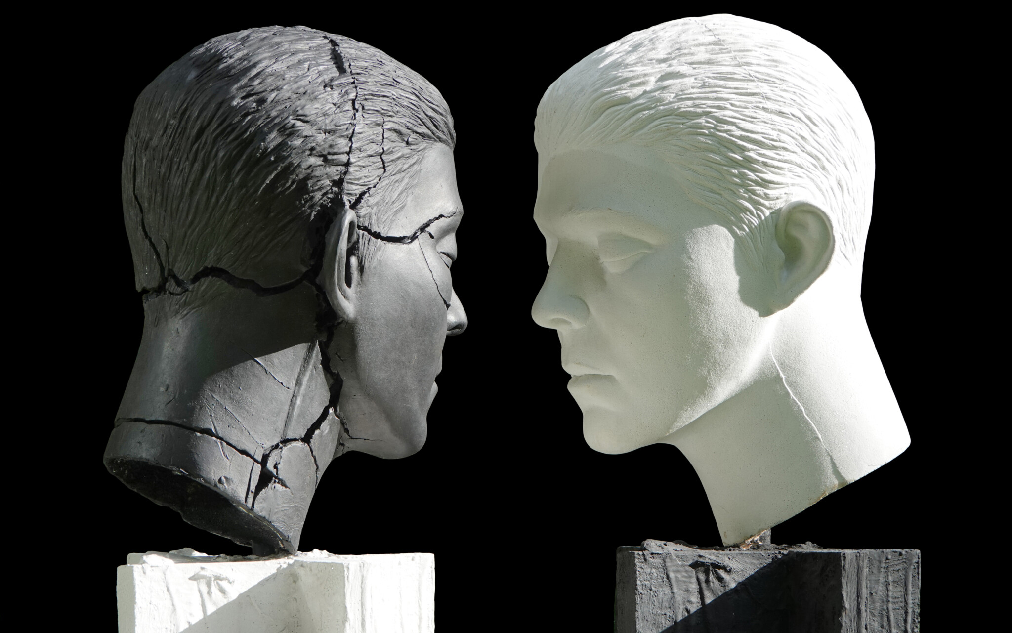 Two heads, in black in white. Part of Mark Humphrey's War Games piece.
